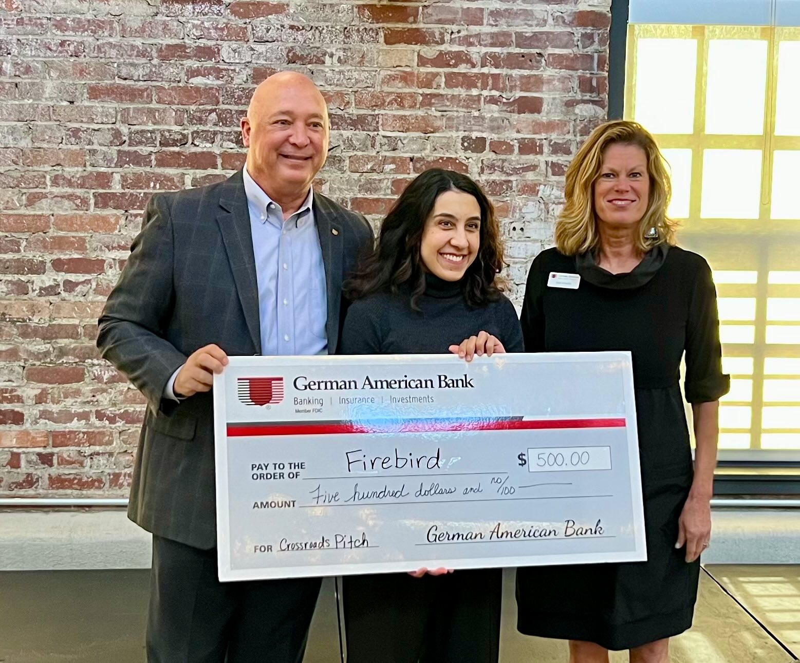 Our Cofounder Andreia holding the big winning check. Photo by Eric Nichols